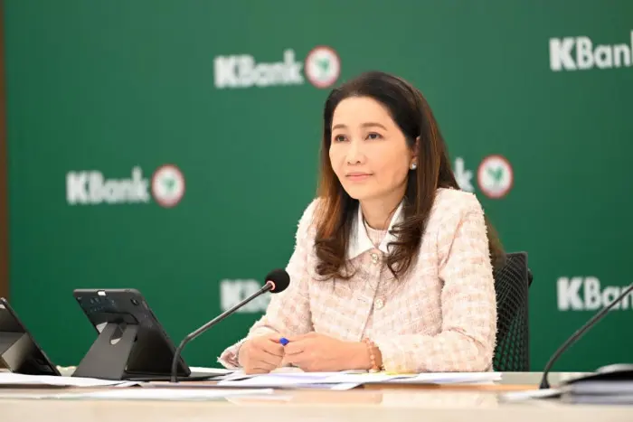 A woman sitting at a desk during a K Bank partnership announcement meeting.