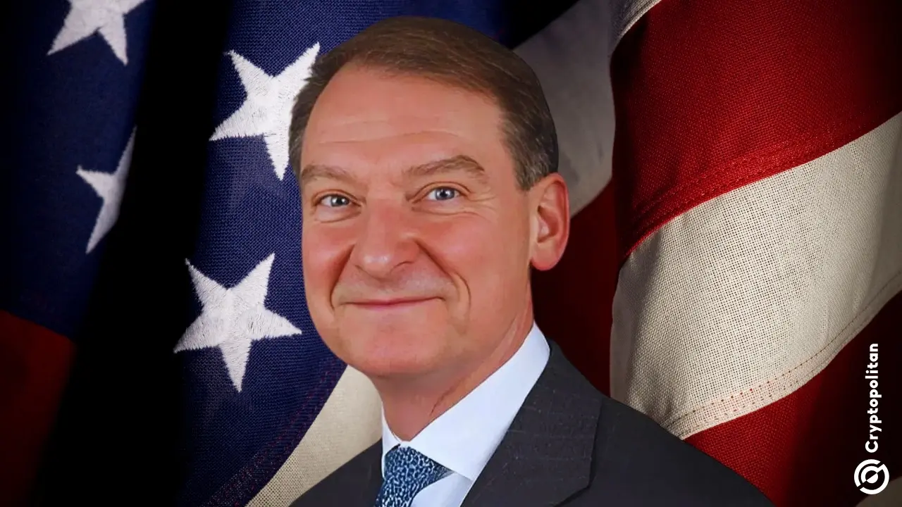 Portrait of Paul Atkins in a suit and tie, posing in front of the United States flag.