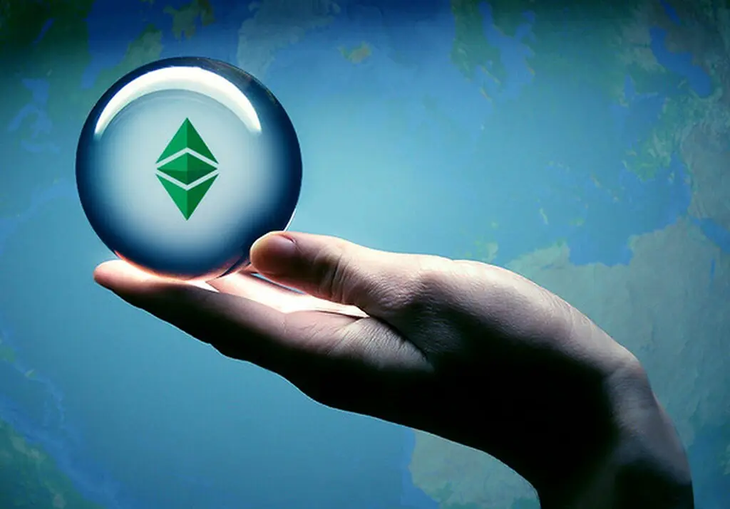 A hand holding a glass sphere featuring the Ethereum logo against a blue map background.
