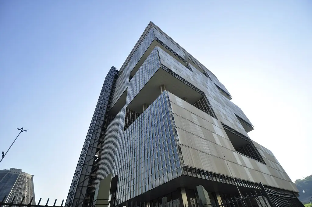 Low-angle view of the modern glass and concrete Petrobras headquarters building under a clear blue sky.